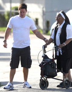 Actor Mark Wahlberg helps an elderly nun cross the street in Miami